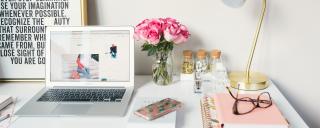 Banner für Blogbeitrag zum Thema Arbeitsrecht zeigt Arbeitsplatz mit Laptop, Rosen und Brille
